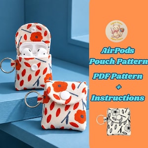 May include: Two fabric pouches for AirPods featuring a white base with an orange floral and leaf pattern, each with a metal keyring and a white snap button closure. One pouch is open showing white earbuds, and a small black and white version is shown.