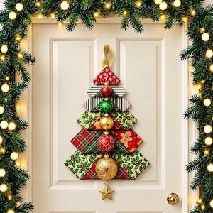 May include: A wall-hanging Christmas tree decoration constructed from folded fabric segments in red, green, and white patterns, accented with round ornaments in red, green, and gold, topped with a gold ribbon loop and finished with a gold star.