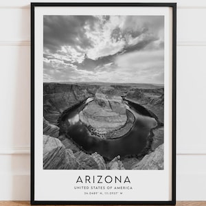 May include: Black and white framed print of Horseshoe Bend in Arizona. The photograph captures the natural landscape of the canyon and the Colorado River. The print includes the word "ARIZONA" and coordinates.