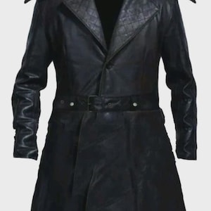 May include: A black long-length coat featuring a pointed hood, structured shoulder epaulets, and a quilted texture on the wide lapels. The garment includes a matching black belt with a metal buckle at the waist and long sleeves with cuffs.