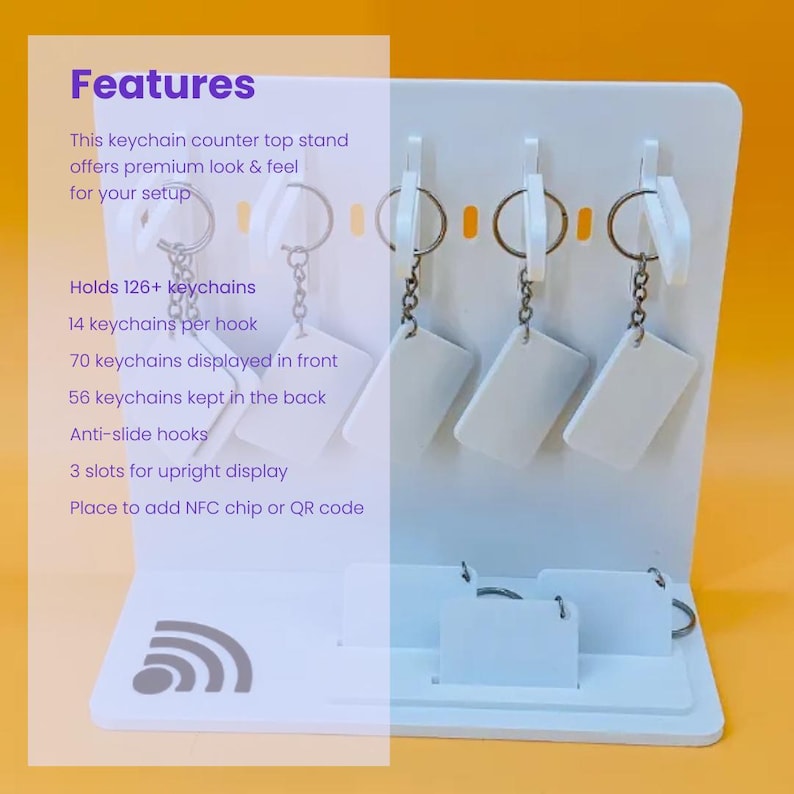 May include: A white countertop display stand for keychains featuring multiple hooks and slots. The stand includes text listing features such as holding 126+ keychains, anti-slide hooks, and a designated area for an NFC chip or QR code on the base.