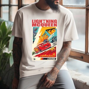 May include: White t-shirt featuring a colorful graphic of Lightning McQueen from the Cars movie. The design includes the text "LIGHTNING McQUEEN RACING SERIES" and the number "95". The graphic has a vintage poster style with racing cars and a checkered flag.