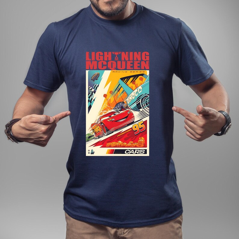 May include: Navy blue t-shirt featuring a graphic of Lightning McQueen from the Cars movie. The design includes the text "LIGHTNING McQUEEN" and "95" with racing elements in a vibrant color palette.