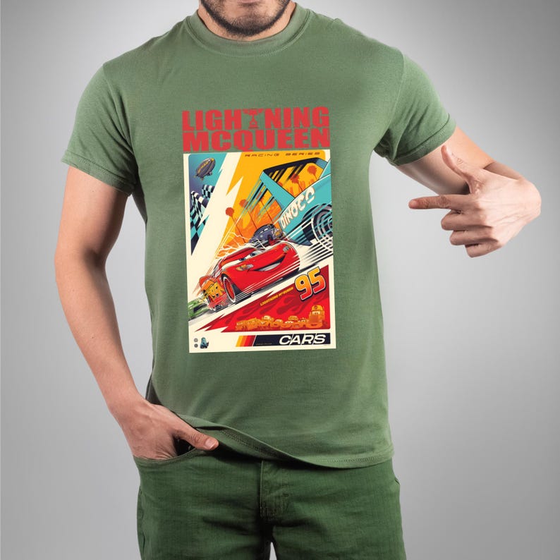 May include: Green t-shirt featuring a colorful graphic of Lightning McQueen from the movie Cars. The graphic includes the text "LIGHTNING McQUEEN" in red, and "95" with the word "CARS" at the bottom.