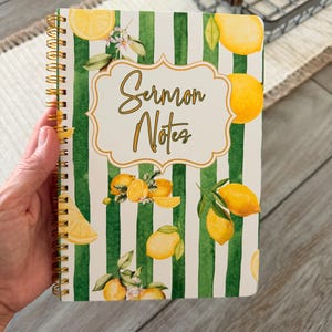 May include: Spiral-bound notebook with a cover featuring green and white stripes, lemons, and the text "Sermon Notes." The notebook has a gold spiral binding. The cover design includes watercolor illustrations of lemons and leaves.