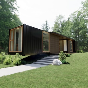 May include: A modern black container home with large windows and a wooden accent wall. The home is set on a grassy hill with a concrete walkway leading to the entrance. Lush green trees surround the house.