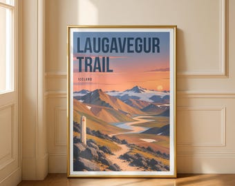 May include: A framed art print featuring the Laugavegur Trail in Iceland, displaying a winding river through mountainous terrain under a sunset sky. The text reads LAUGAVEGUR TRAIL and ICELAND in dark blue letters against a soft orange and blue background.