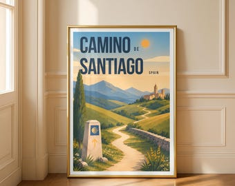 May include: A framed wall art print featuring a landscape illustration of the Camino de Santiago in Spain. The image displays a winding path, a stone marker with a scallop shell symbol, rolling green hills, mountains, and a distant building.