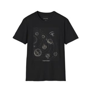 May include: Black t-shirt featuring a detailed illustration of a planetary system with planets and orbits. The design includes the text "WHERE?" and "STREETCORNER". The shirt is a classic crew neck style.