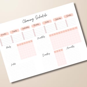 May include: A white paper titled "Cleaning Schedule" with a handwritten font. The schedule includes daily, monthly, quarterly, and annual sections. Days of the week are listed across the top in a pink font.