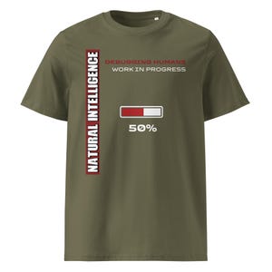 May include: Khaki green t-shirt with the text "NATURAL INTELLIGENCE" in a vertical red and white bar on the left. The shirt also features the text "DEBUGGING HUMANS WORK IN PROGRESS" and a loading bar graphic showing 50% completion.