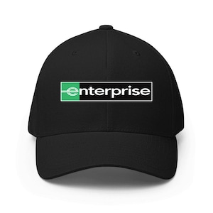 Pode incluir: Boné de beisebol preto com a palavra "enterprise" em texto branco dentro de um retângulo preto com borda verde. O boné tem uma viseira curva e um design clássico de seis painéis.
