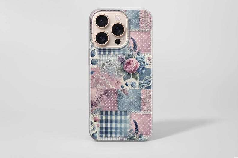 May include: A phone case with a patchwork design featuring floral and lace patterns in shades of pink and blue. The case has a clear border and a camera cutout. The design includes a pink rose and blue gingham.