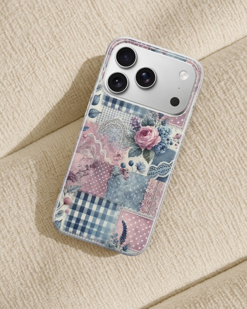 May include: A clear phone case with a patchwork design featuring floral and gingham patterns in shades of pink, blue, and white. The case has a clear border and a silver camera module.