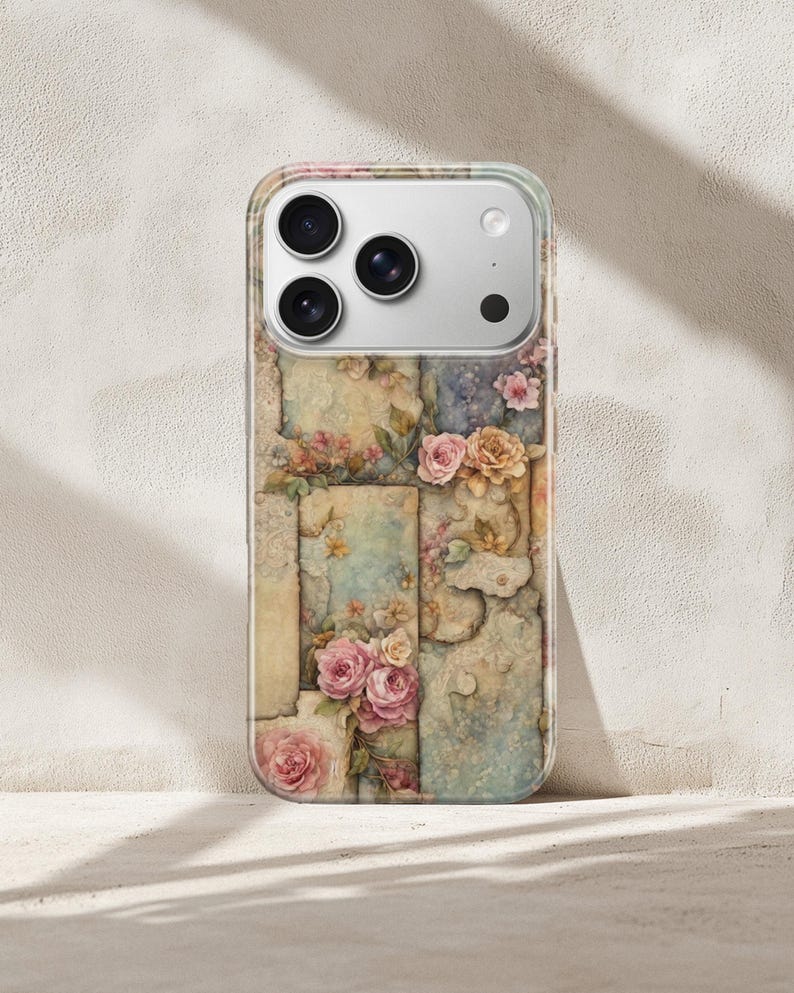 May include: A clear phone case with a floral pattern of pink and yellow roses, set against a backdrop of faded, textured panels in muted tones. The case has a clear border and a camera cutout.