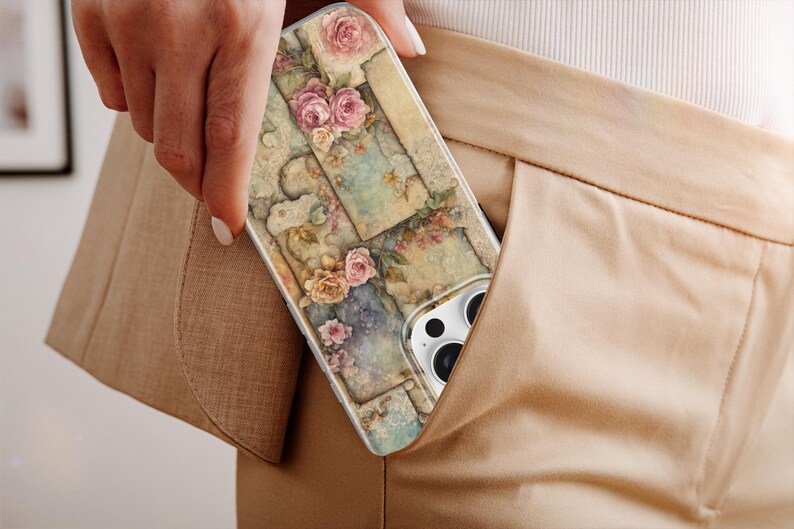 May include: A phone case with a floral design, featuring pink and peach roses on a collage of vintage-style images. The case is partially visible in a tan pocket, highlighting its design and colour scheme.