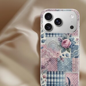 May include: A phone case with a patchwork design featuring floral and lace patterns in pink, blue, and white. The case has a clear border and a camera cutout.