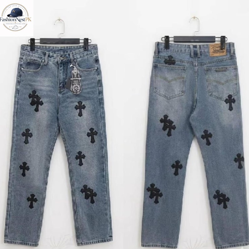 May include: Light blue denim jeans featuring multiple black cross appliqu&eacute;s. The jeans have a classic five-pocket design and a straight leg fit. The front and back of the jeans are visible, showcasing the placement of the crosses.