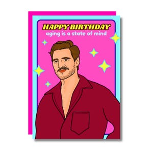 May include: A birthday card featuring a cartoon illustration of a man in a red shirt. The card has a pink background with yellow stars and the text "HAPPY BIRTHDAY aging is a state of mind."