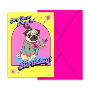 May include: A yellow greeting card with a pink arch and a cartoon pug wearing a top hat with a pink feather, a paisley blazer, and a pink neck scarf. The pug holds a martini glass. The text reads It's Your Puggin' Birthday! A hot pink envelope.