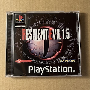 May include: A clear plastic jewel case for a PlayStation video game titled Resident Evil 1.5. The cover art features a large, dark, reptilian eye with a vertical pupil, the PlayStation logo, the PAL label, and the Virgin Interactive and Capcom logos.
