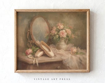 May include: A framed oil painting print featuring a pair of pale pink ballet slippers resting on a wooden surface next to a white ceramic pitcher filled with pink roses, a small oval mirror, a string of white pearls, and draped fabric.