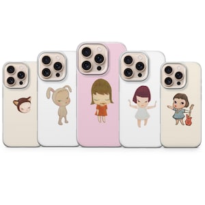 May include: Five phone cases with unique cartoon character designs. The cases feature a cat, a bunny, a girl in a red dress, a girl with arms outstretched, and a girl with a guitar. The cases are in various colors, including pink and white.