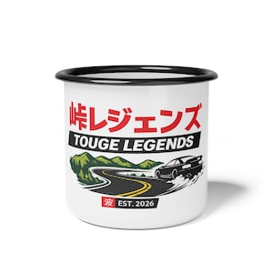 May include: White enamel mug with a black rim featuring Japanese text and the words "TOUGE LEGENDS". A black car drifts on a winding road graphic. The mug also has the text "EST. 2026".
