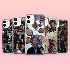 May include: A collection of five phone cases featuring images of the television show "House". The cases display various collages of the show's characters, with a clear case in the center. The background is a soft pink.