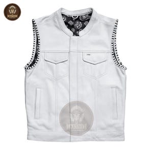 May include: A white leather vest with a black paisley patterned lining and decorative stitching along the edges. The vest has two chest pockets and two lower pockets. The vest has a Native Leather Jackets logo.
