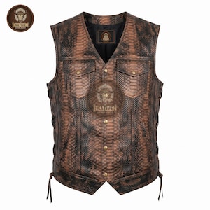 May include: Brown leather vest with a snakeskin pattern, featuring two chest pockets and a V-neck. The vest has a button-up front and decorative side laces. The Native Leather Jackets logo is visible on the vest and in the upper left corner.