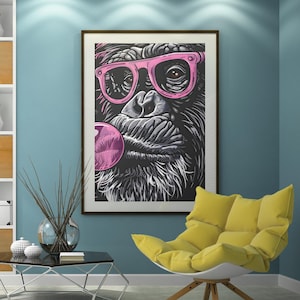 May include: A framed print showing a gorilla in pink sunglasses blowing a bubblegum bubble. The black and white artwork hangs in a room with a yellow armchair and a modern coffee table. The room is painted in shades of blue.
