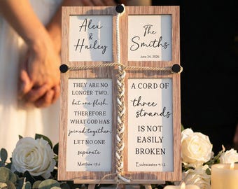 May include: A wooden framed wedding sign with the names "Alex & Hailey" and "The Smiths" with the date June 24, 2026. The sign includes Bible verses and a braided rope design. The sign is on a small wooden easel.