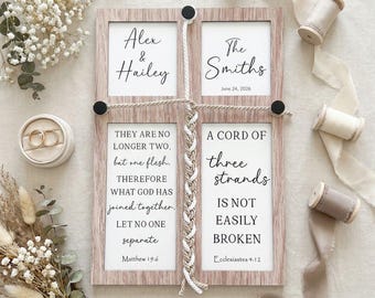 May include: A wooden wedding sign with four framed panels. The top panels read "Alex & Hailey" and "The Smiths June 24, 2026." The bottom panels feature Bible verses about marriage. A braided rope and black accents connect the panels. Gold wedding rings are in a ring box.