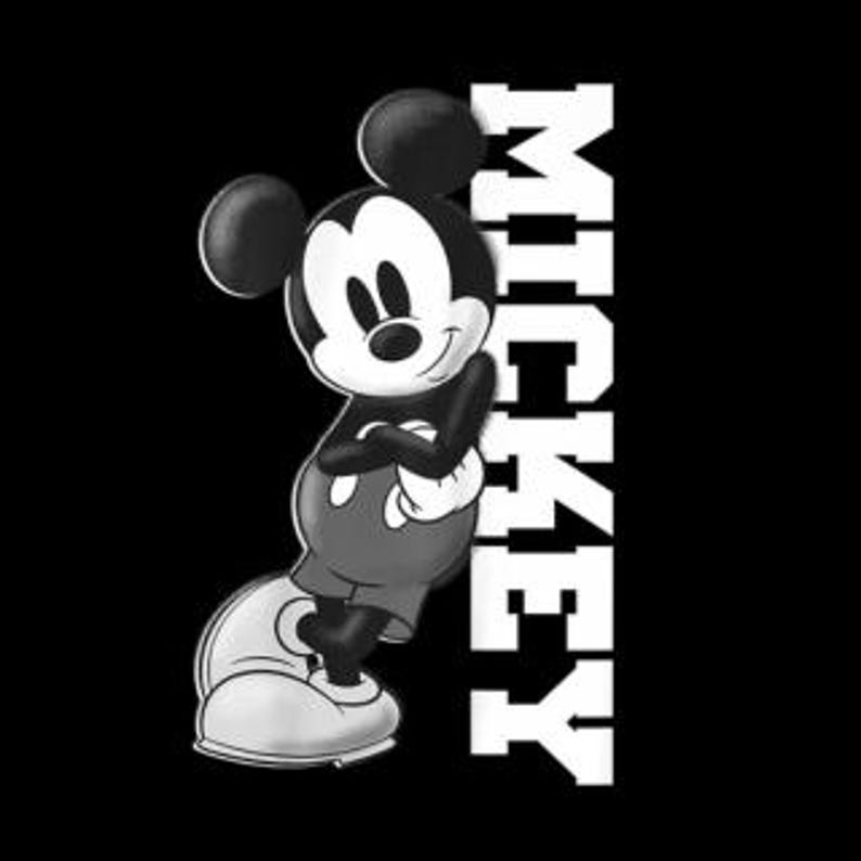 May include: Black and white graphic of Mickey Mouse with arms crossed, smiling. Mickey is wearing white gloves, shorts, and shoes. The word "MICKEY" is printed vertically in white on the right side of the image.