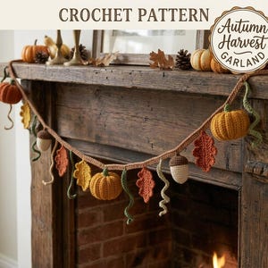 May include: A crochet pattern for an Autumn Harvest Garland featuring a brown yarn string decorated with crocheted orange and yellow pumpkins, brown and cream acorns, red and yellow oak leaves, and green curly vines, with text reading CROCHET PATTERN.
