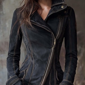 Könnte beinhalten: Schwarze Jeansjacke mit diagonalem Reißverschluss und Reverskragen. Die Jacke hat sichtbare beige Nähte und eine taillierte Silhouette. Die Ärmel haben geknöpfte Manschetten. Ein stilvolles Oberbekleidungsstück.