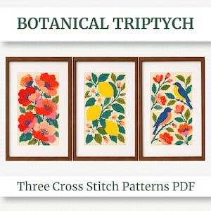 May include: A framed botanical triptych featuring three cross-stitch patterns. The patterns include vibrant red and pink flowers, yellow lemons with green leaves, and blue birds with orange accents. The text reads "BOTANICAL TRIPTYCH" and "Three Cross Stitch Patterns PDF."