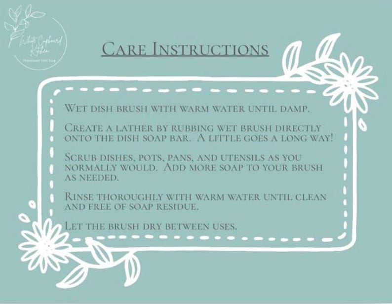 May include: A light blue rectangular sign with white floral borders and the text CARE INSTRUCTIONS. It provides steps for using a dish brush and soap bar, including wetting the brush, creating a lather, scrubbing dishes, rinsing, and drying the brush.