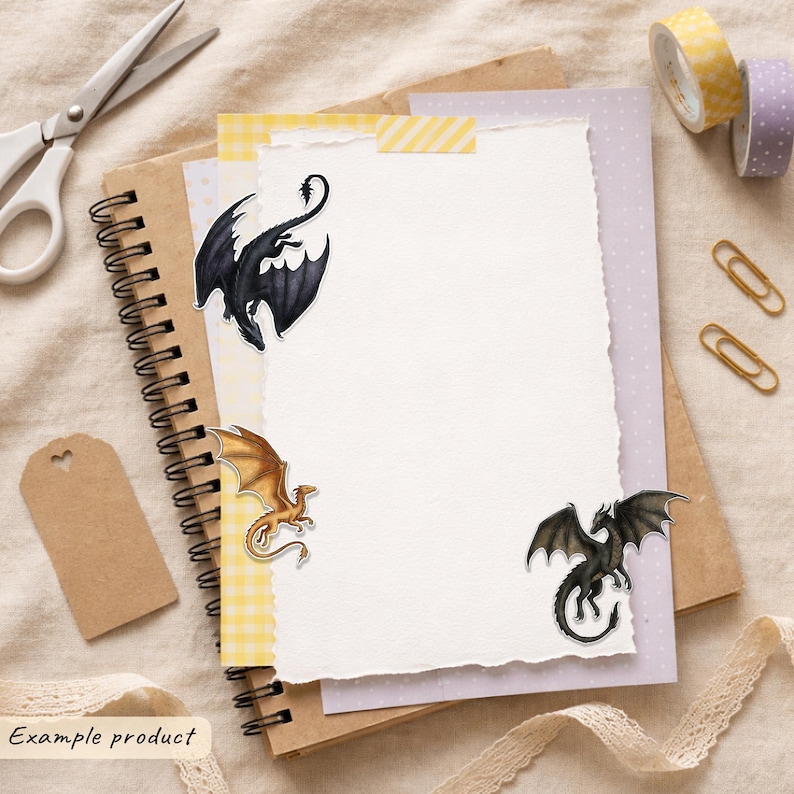 May include: A stack of stationery featuring a spiral-bound notebook, a sheet of yellow gingham paper, and a white deckle-edge paper. Three dragon stickers are attached: a black dragon, a gold dragon, and a dark green dragon with wings.
