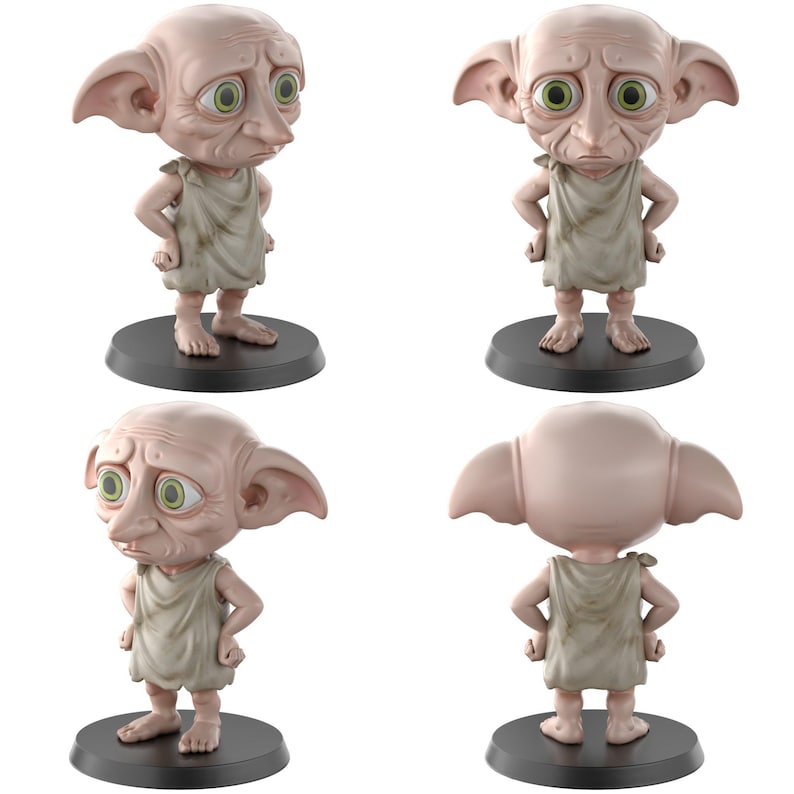 May include: A figurine of a character with large ears, green eyes, and a sad expression. The figure is wearing a tan tunic and standing on a black circular base. The image shows the figurine from multiple angles.
