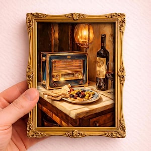 May include: A miniature painting in a gold frame depicts a still life with a vintage blue radio, a bottle of wine, a glass, and a plate of olives and bread. A small lamp illuminates the scene, creating a warm, inviting atmosphere.