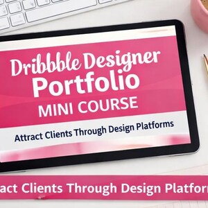 May include: A tablet displays the text "Dribbble Designer Portfolio MINI COURSE" in white on a pink background. The phrase "Attract Clients Through Design Platforms" is also visible. A keyboard, pen, and coffee cup are nearby.