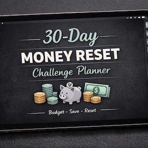 May include: A tablet displays a "30-Day Money Reset Challenge Planner" graphic with a piggy bank, stacks of coins, and a dollar bill. A cup of coffee, a pen, and coins are on the dark surface.