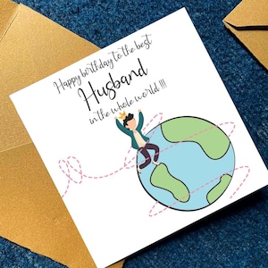 May include: A birthday card with the message "Happy birthday to the best Husband in the whole world!!!" features a cartoon of a person wearing a crown standing on a globe. The card is white with a gold envelope.