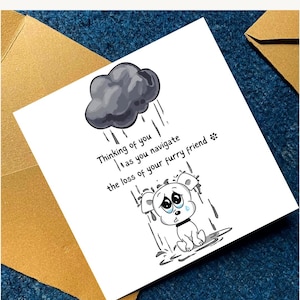 May include: A white greeting card with a cartoon illustration of a sad puppy under a rain cloud. The card includes the text: "Thinking of you as you navigate the loss of your furry friend."