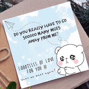May include: A greeting card with a light blue background and a cartoon bear illustration. The card has text that reads "DO YOU REALLY HAVE TO GO SOOOOO MANY MILES AWAY FROM ME? LOOOTSSSS OF LOVE FOR YOU !!! Until we meet again?"