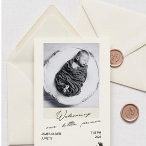 May include: A cream-coloured birth announcement card featuring a black and white photograph of a swaddled newborn. The text reads Welcoming our little prince, James Oliver, June 13, 7 45 PM, 2026. Includes two cream envelopes with wax seals.