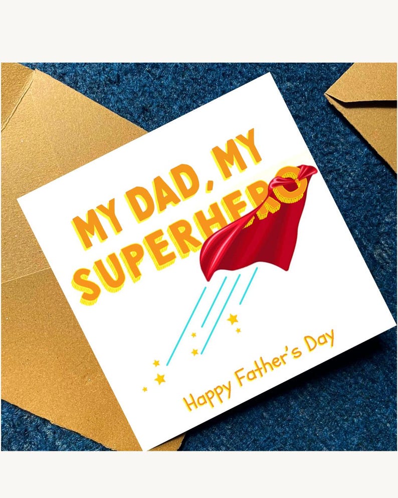 May include: A square greeting card with a white background featuring the yellow text MY DAD, MY SUPERHERO. A red cape is attached to a yellow ring, with light blue motion lines and small yellow stars below. The text Happy Father's Day is in yellow.