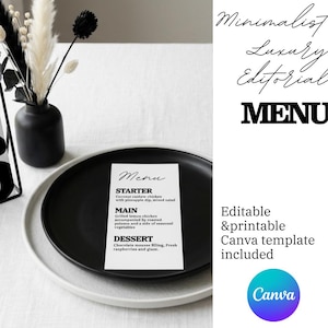 Op de afbeelding: Een minimalistische menukaart op een zwart bord, met een voorgerecht, hoofdgerecht en dessert. Het menu staat op een wit tafelkleed, met een zwarte vaas met gedroogde bloemen. Het woord "MENU" staat prominent weergegeven.